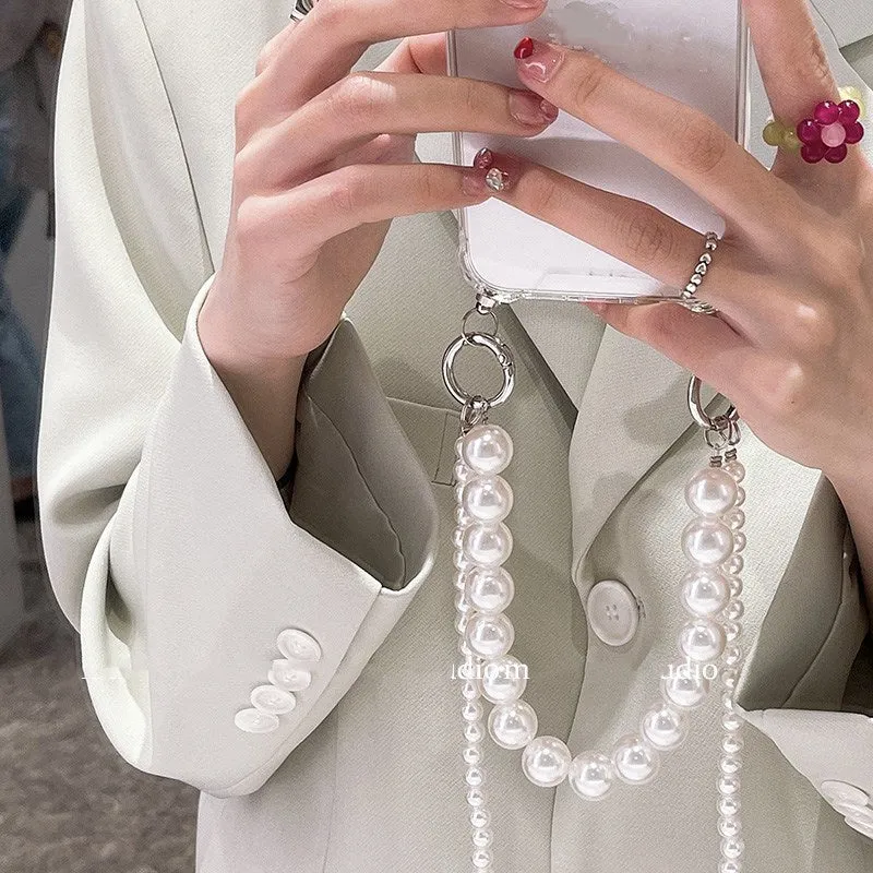 Soft Apple iPhone case with a large white pearl decoration and a silver chain attached.