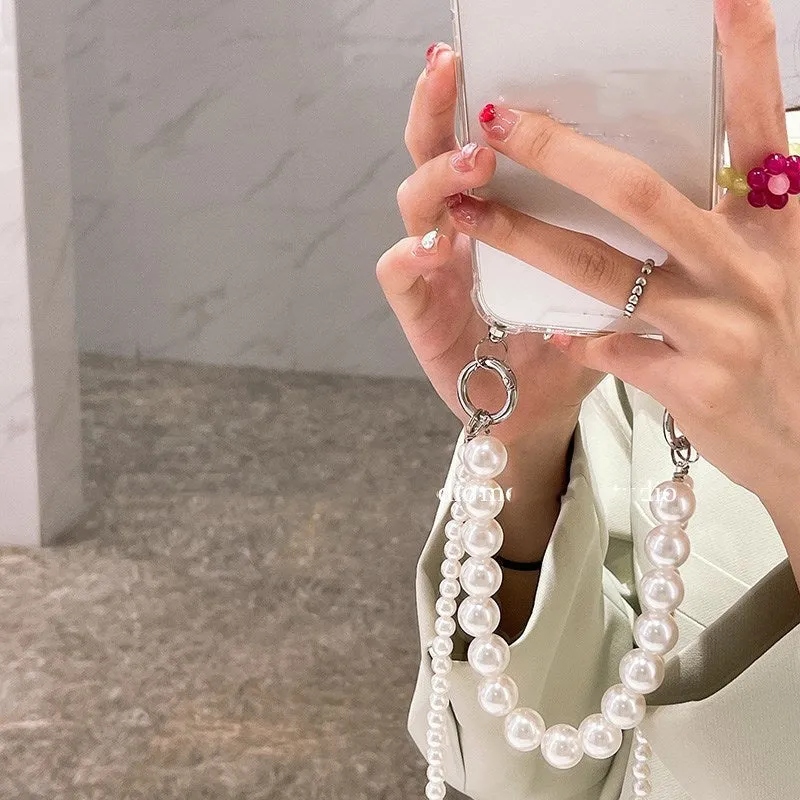 Soft Apple iPhone case with a large white pearl decoration and a silver chain attached.