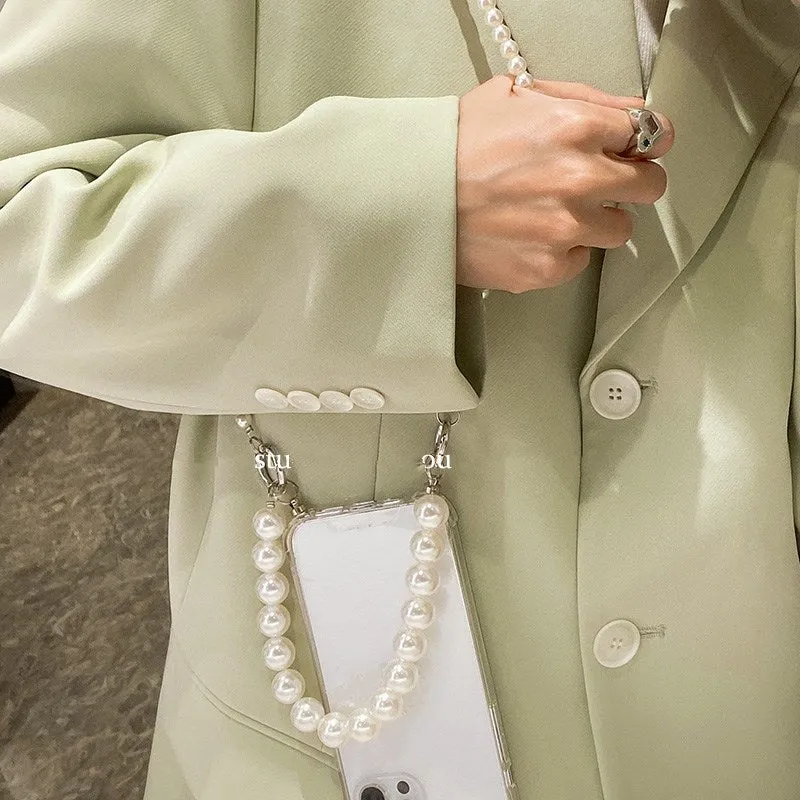 Soft Apple iPhone case with a large white pearl decoration and a silver chain attached.