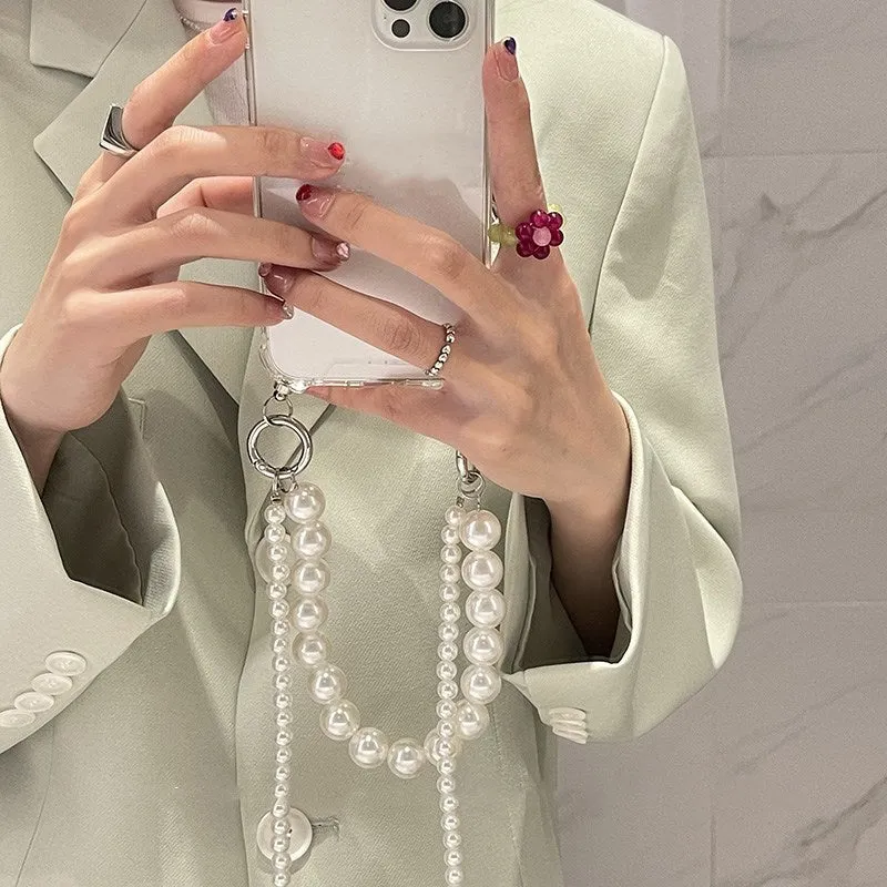 Soft Apple iPhone case with a large white pearl decoration and a silver chain attached.