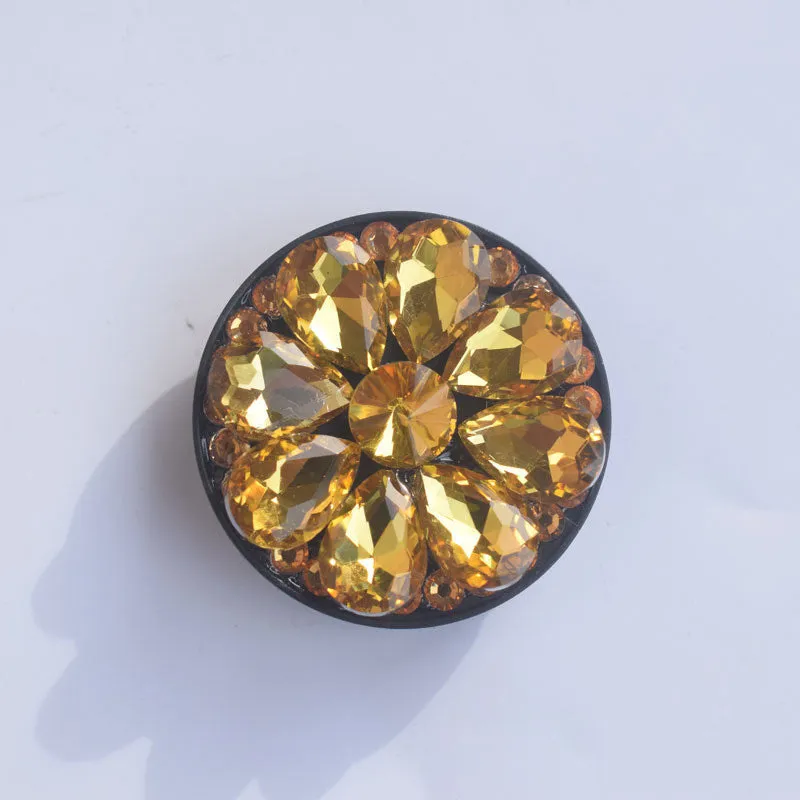 Rhinestone ring bracket phone holder for Apple and Android mobile phones on a desktop.