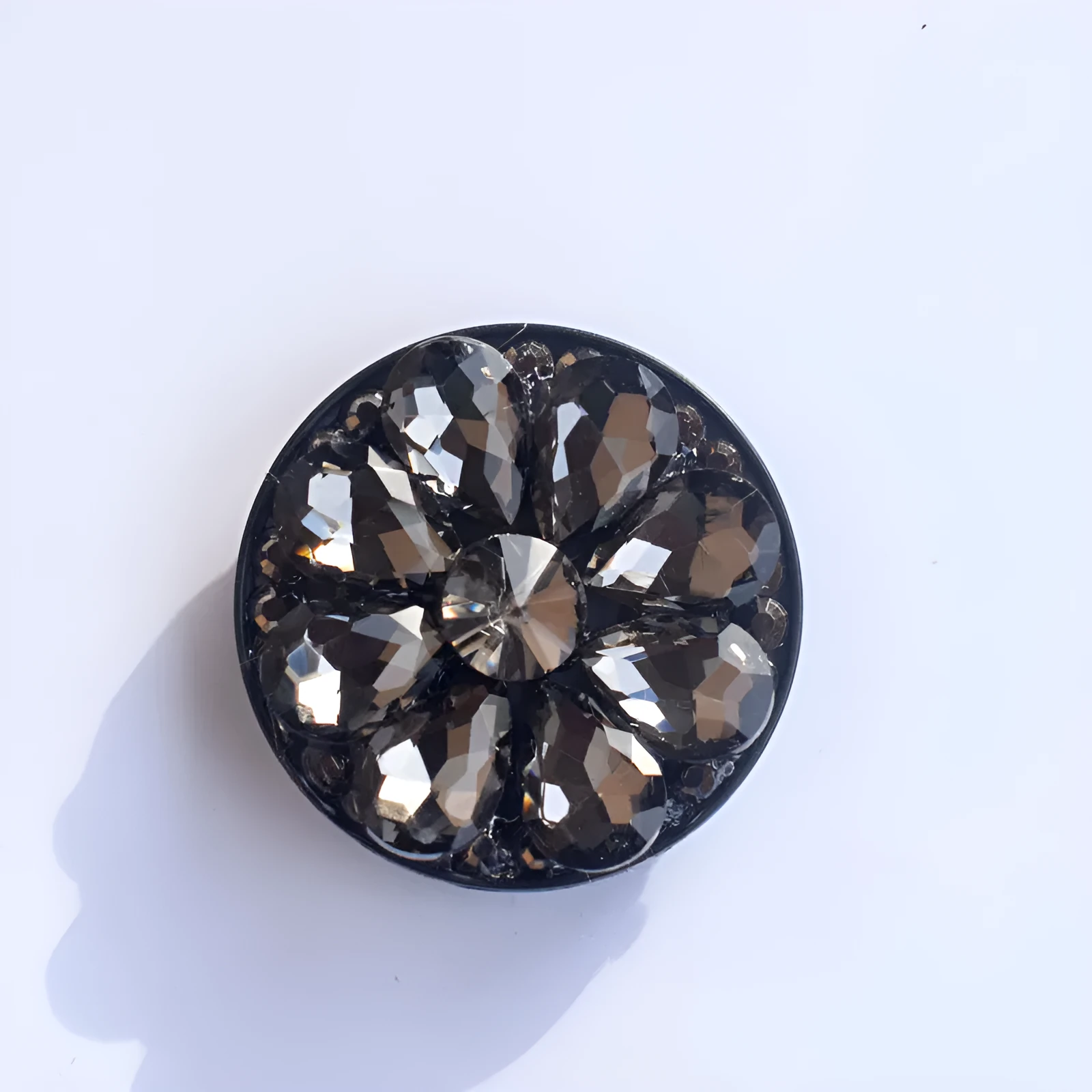 Rhinestone ring bracket phone holder for Apple and Android mobile phones on a desktop.