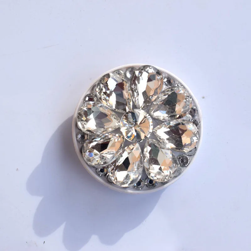 Rhinestone ring bracket phone holder for Apple and Android mobile phones on a desktop.
