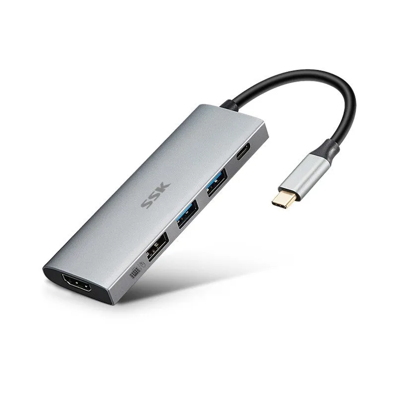 Grey 11-in-1 USB-C docking station with HDMI, VGA, USB ports, Ethernet, and card reader on a desk.