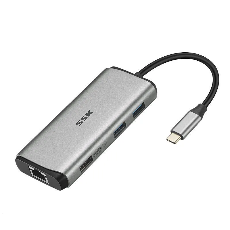 Grey 11-in-1 USB-C docking station with HDMI, VGA, USB ports, Ethernet, and card reader on a desk.