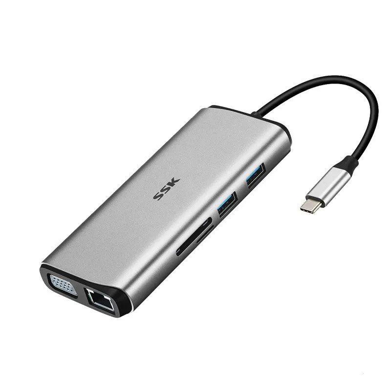 Grey 11-in-1 USB-C docking station with HDMI, VGA, USB ports, Ethernet, and card reader on a desk.