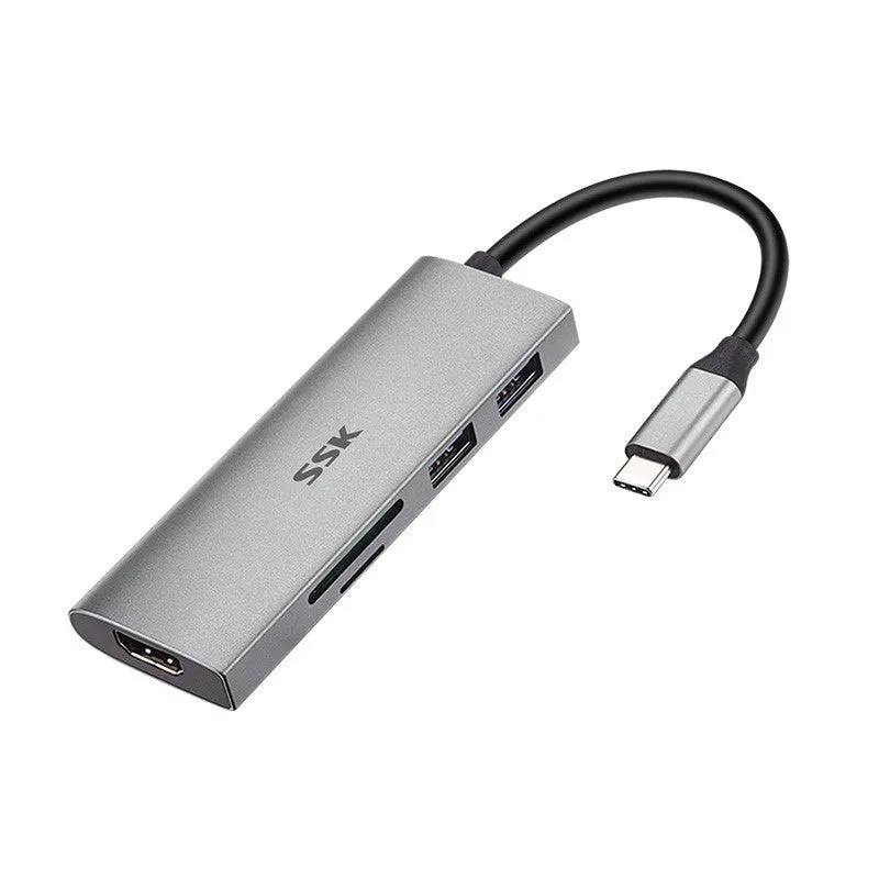 Grey 11-in-1 USB-C docking station with HDMI, VGA, USB ports, Ethernet, and card reader on a desk.
