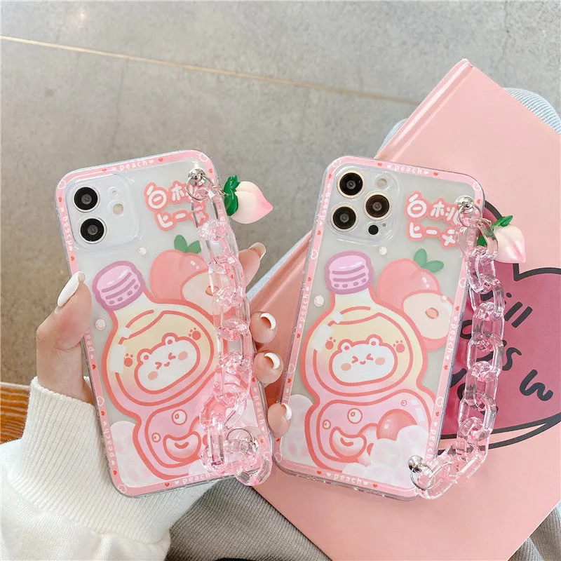 White silicone iPhone case with cartoon peach juice drink and bear design, shown with attached wrist strap.