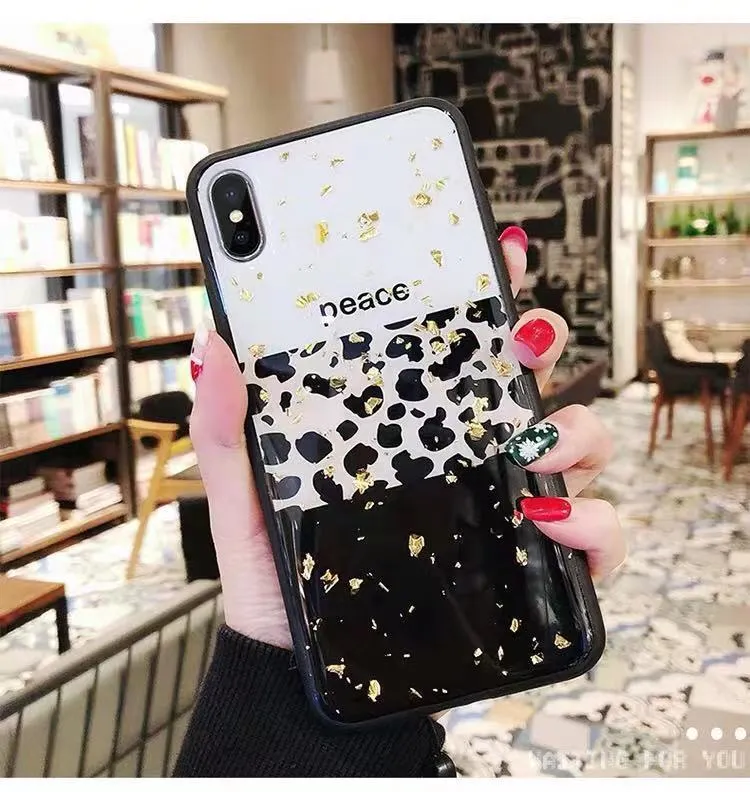 Leopard print pattern TPU back cover case for a mobile phone on a table.