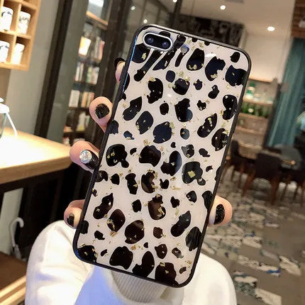 Leopard print pattern TPU back cover case for a mobile phone on a table.