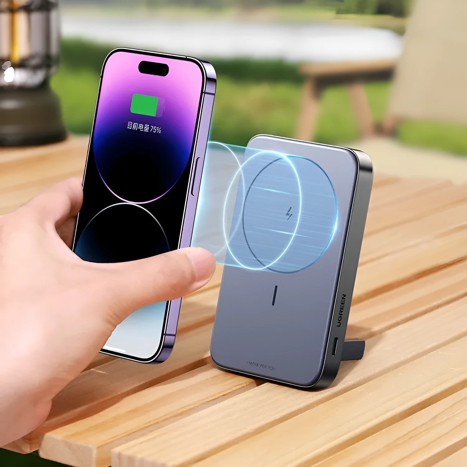 Small black portable magnetic bracket power bank with 10000mAh capacity on a table.