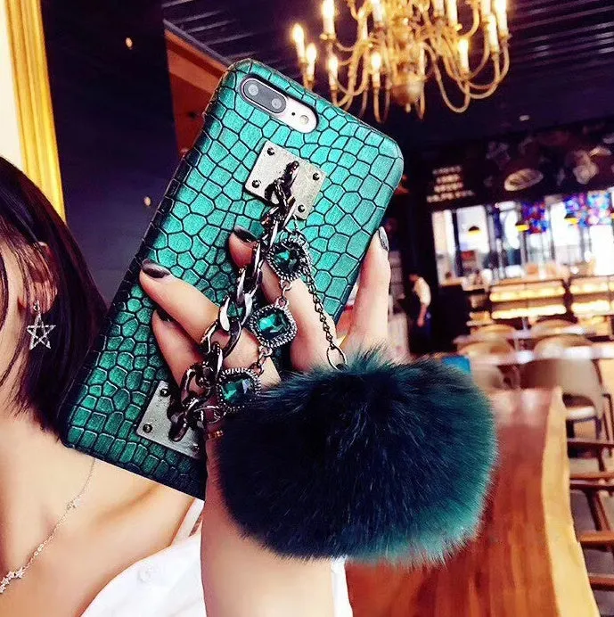 Red iPhone case with rhinestone decoration and attached fox fur ball showing Japanese Korean style design
