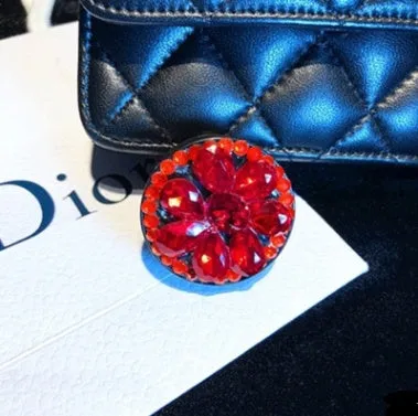 Rhinestone-decorated airbag-style car phone holder with telescopic bracket extended, showing 360-degree swivel mechanism.