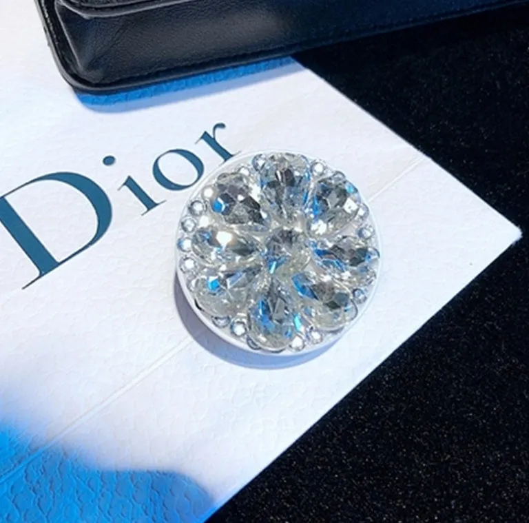 Rhinestone-decorated airbag-style car phone holder with telescopic bracket extended, showing 360-degree swivel mechanism.