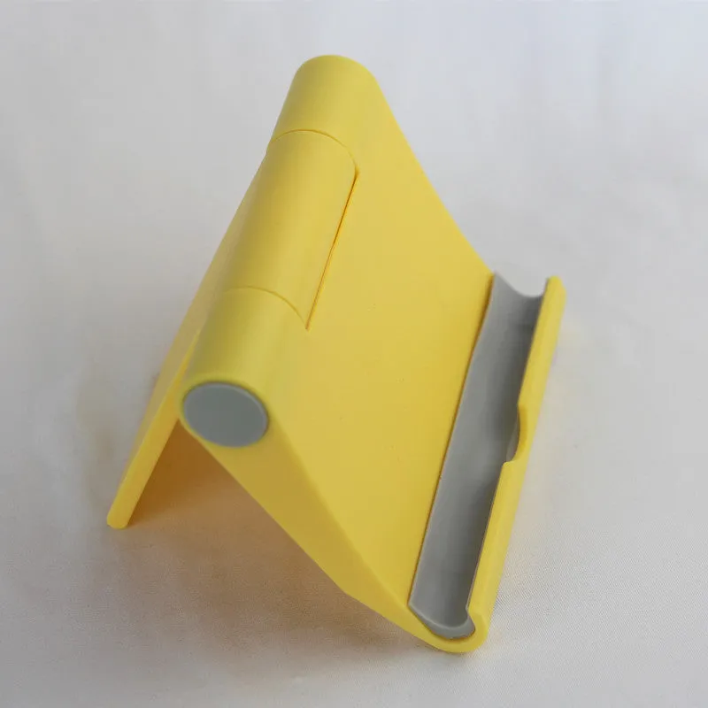 Anti-slip foldable phone holder with silicone pad in black, unfolded on a desk