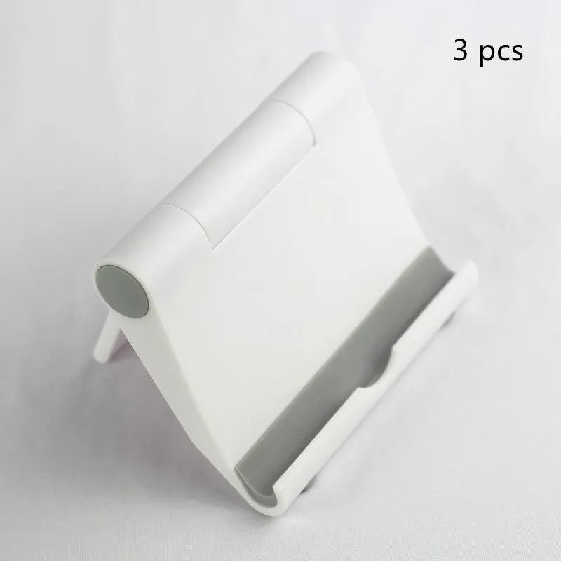 Anti-slip foldable phone holder with silicone pad in black, unfolded on a desk