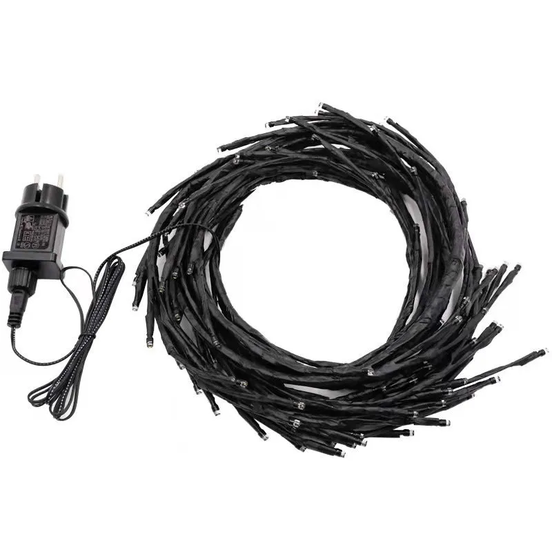 Flexible plastic LED vine garland with warm white lights shaped on a wall.
