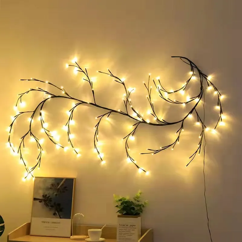 Flexible plastic LED vine garland with warm white lights shaped on a wall.