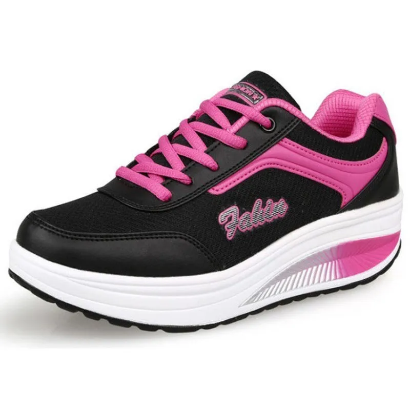 Women's black heelless sports shoes with a medium 3-5cm heel on a white background.