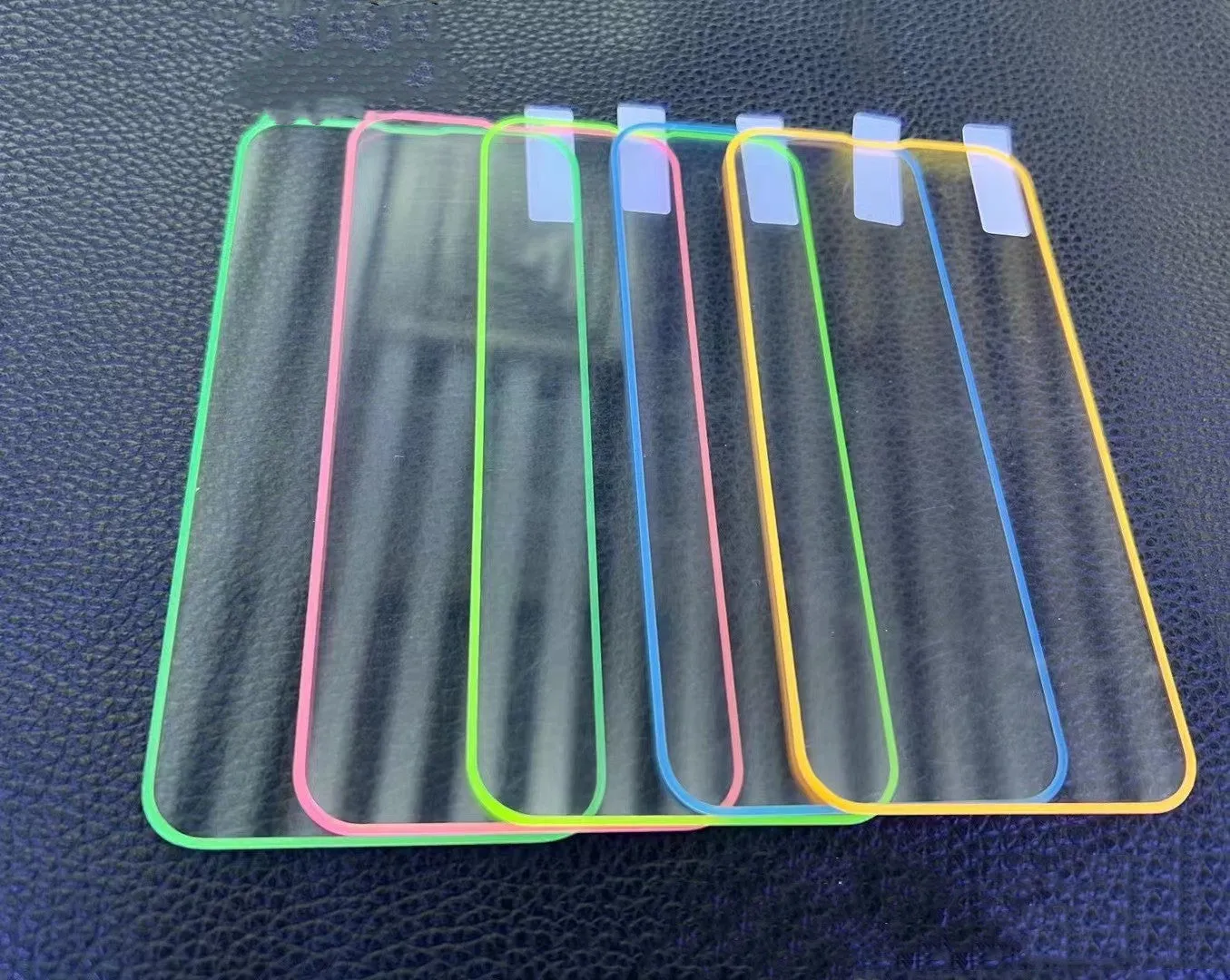 Fluorescent tempered glass screen protector for iPhone in blue luminous colour showing full front coverage.