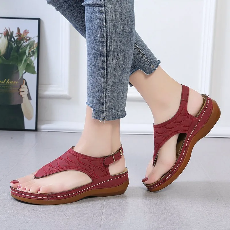 Women's red casual wedge heel sandals with an adjustable buckle strap on a white background.