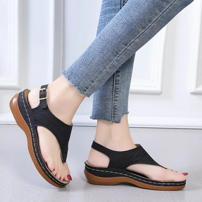 Women's red casual wedge heel sandals with an adjustable buckle strap on a white background.