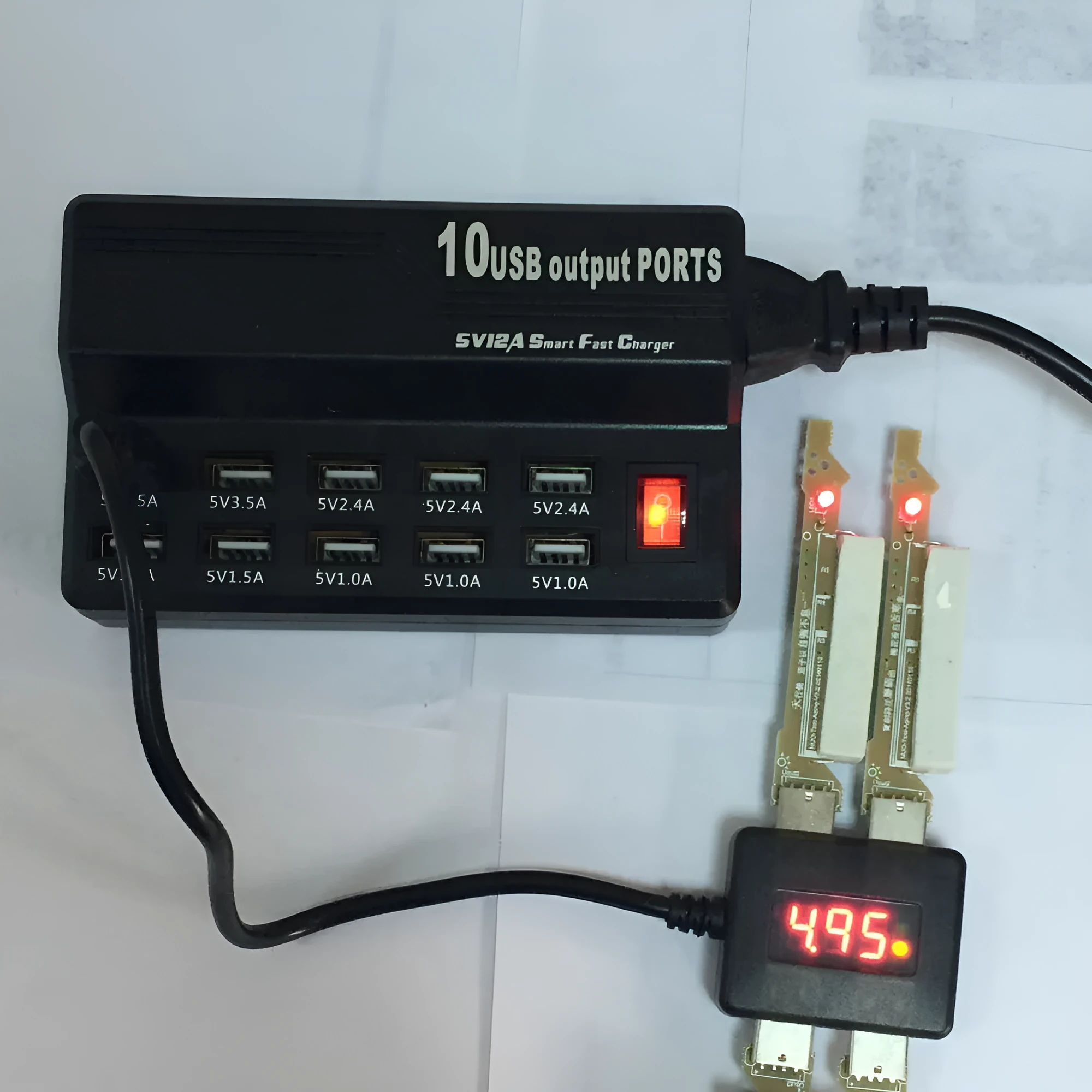 Black 10-port USB charging power strip with smart charging and aluminium heat dissipation, shown with multiple cables connected