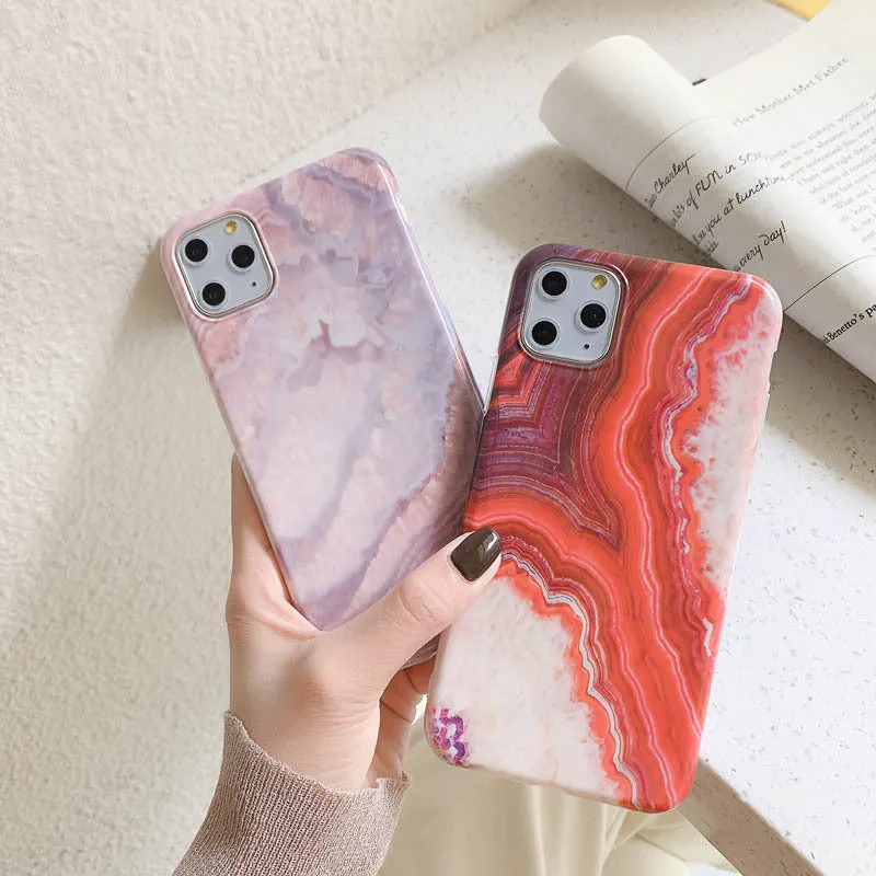 Purple marbled TPU phone case back cover for iPhone sitting on a surface