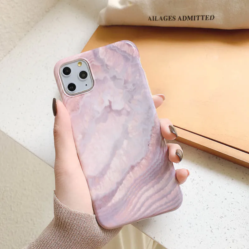 Purple marbled TPU phone case back cover for iPhone sitting on a surface