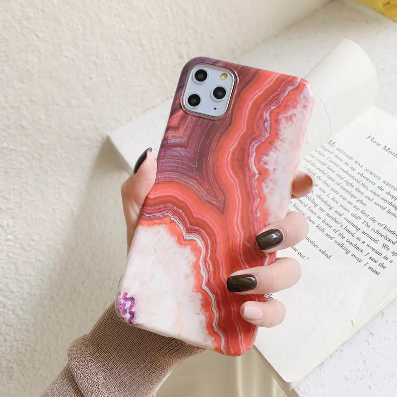 Purple marbled TPU phone case back cover for iPhone sitting on a surface