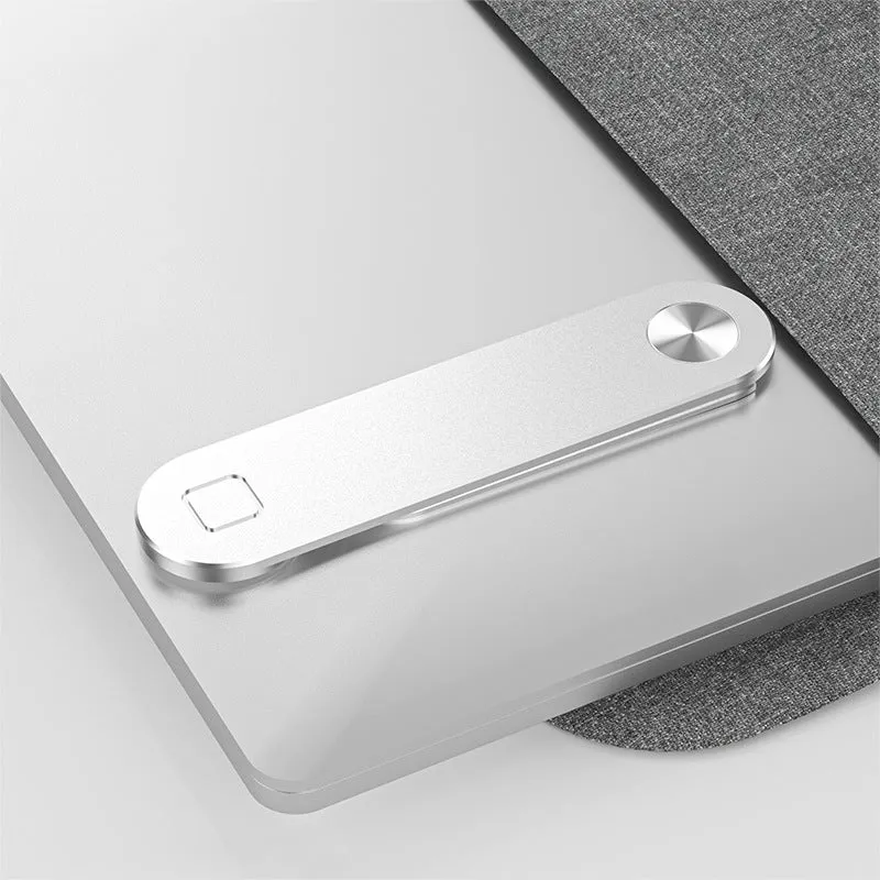 Black aluminium laptop phone holder with magnetic clip attached to laptop edge holding a smartphone