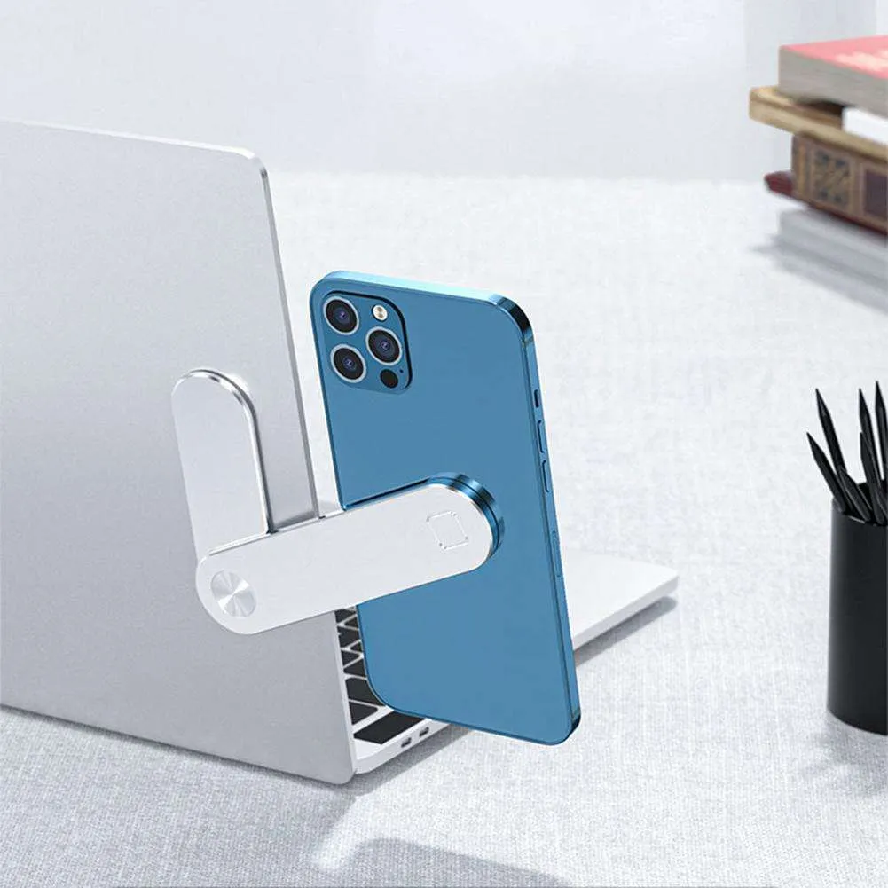 Black aluminium laptop phone holder with magnetic clip attached to laptop edge holding a smartphone