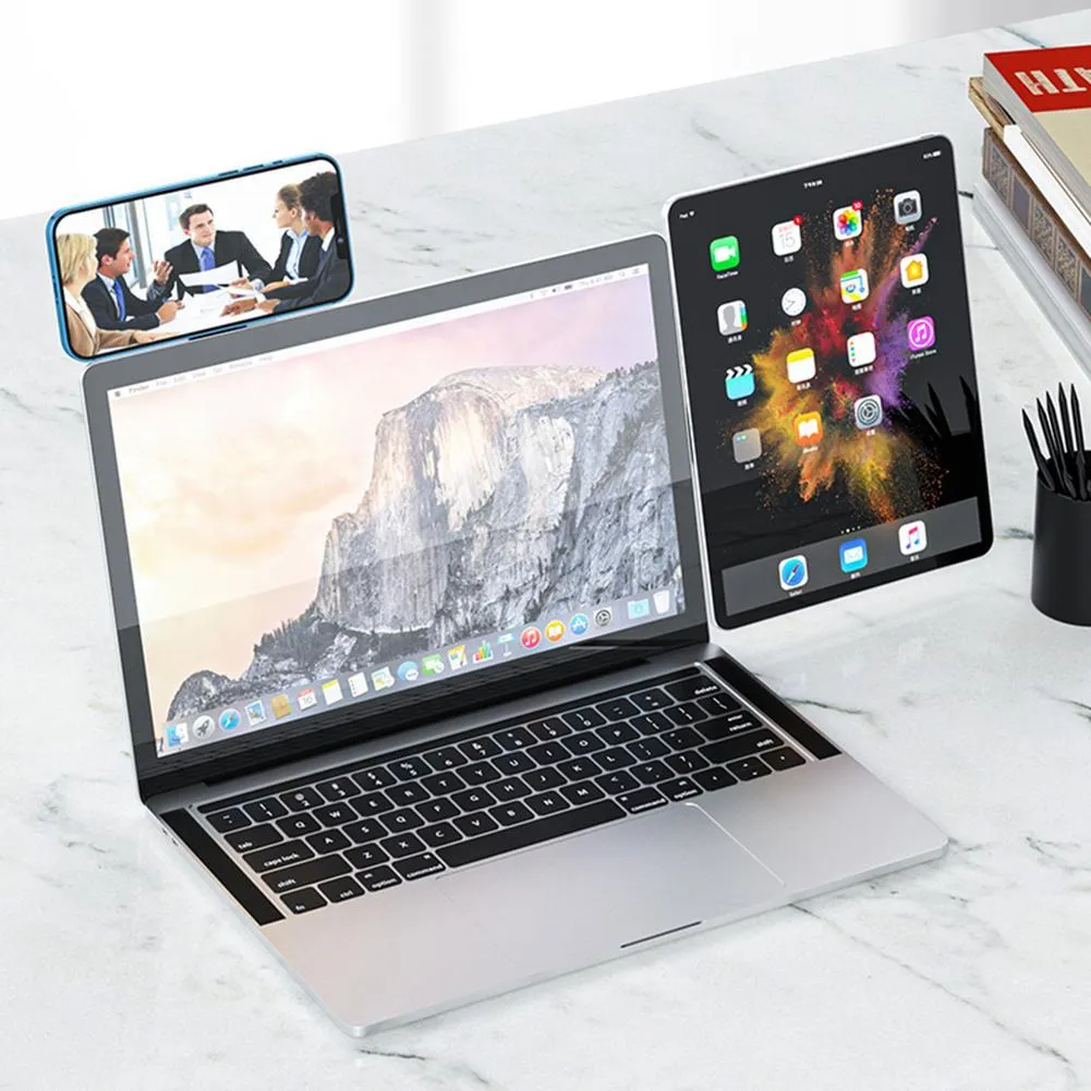 Black aluminium laptop phone holder with magnetic clip attached to laptop edge holding a smartphone