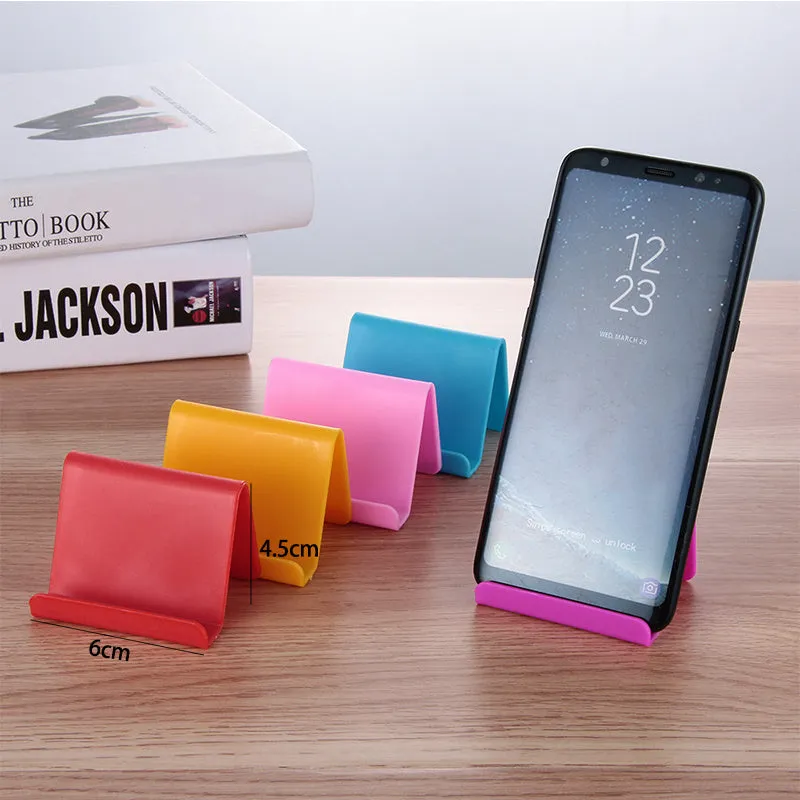 Plastic mobile phone stand in irregular shape on a desk, 6x4.5cm, in blue colour