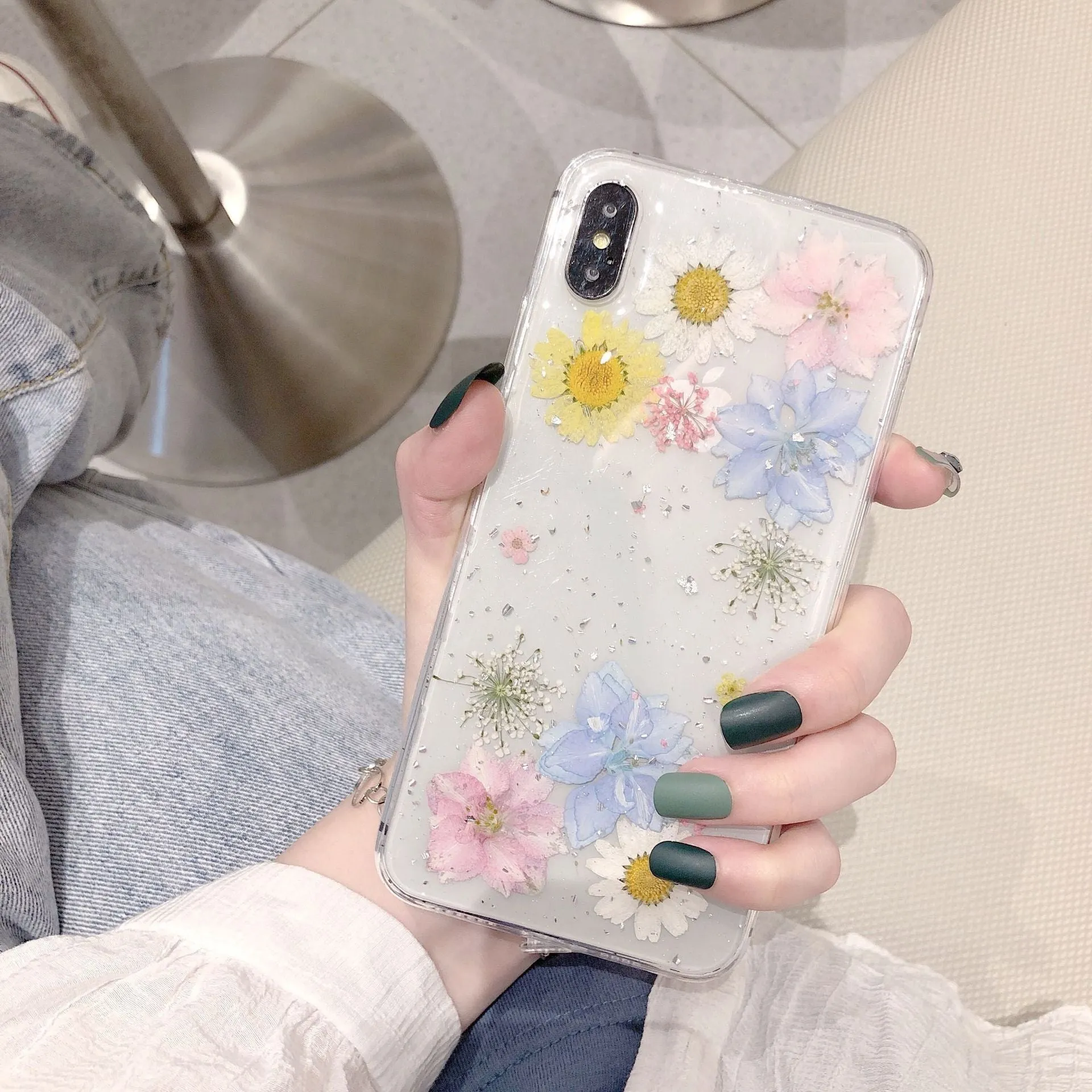 Transparent TPU phone case with real dried daisy flowers and gold glitter under clear epoxy coating