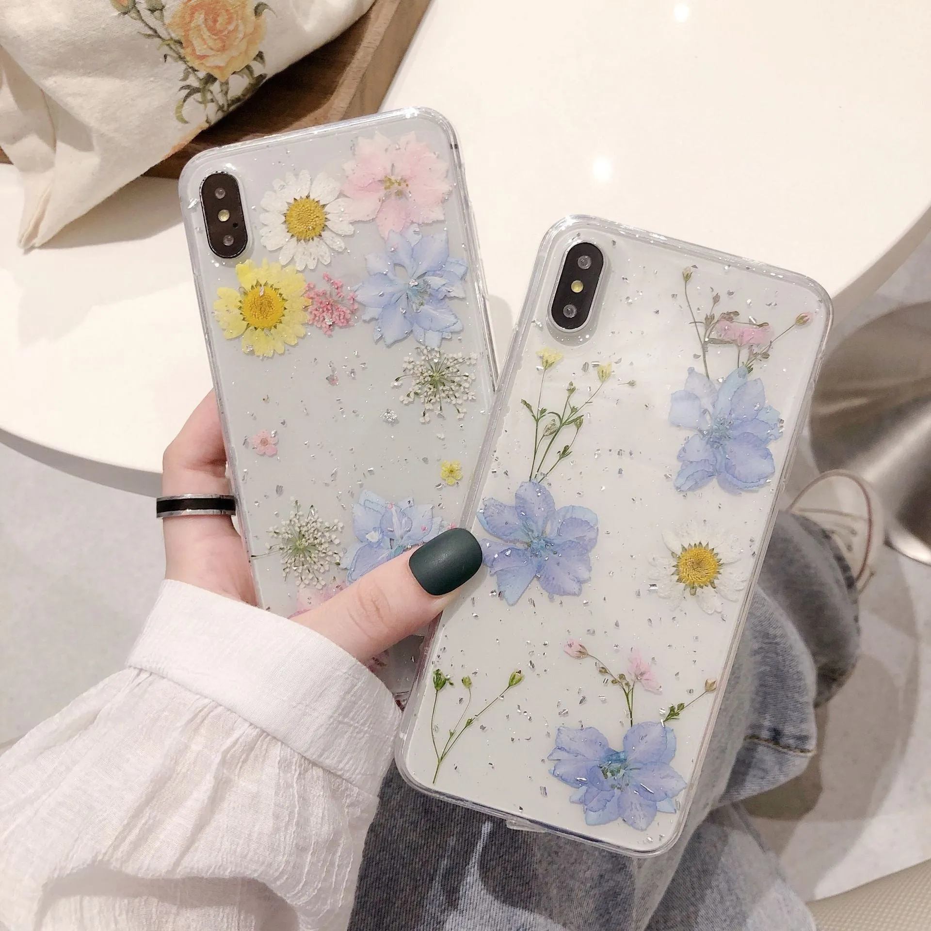 Transparent TPU phone case with real dried daisy flowers and gold glitter under clear epoxy coating