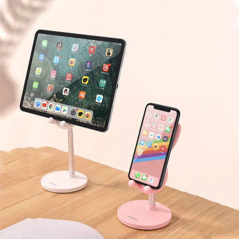 Rabbit-shaped silicone phone stand in pink on a desk with a mobile phone