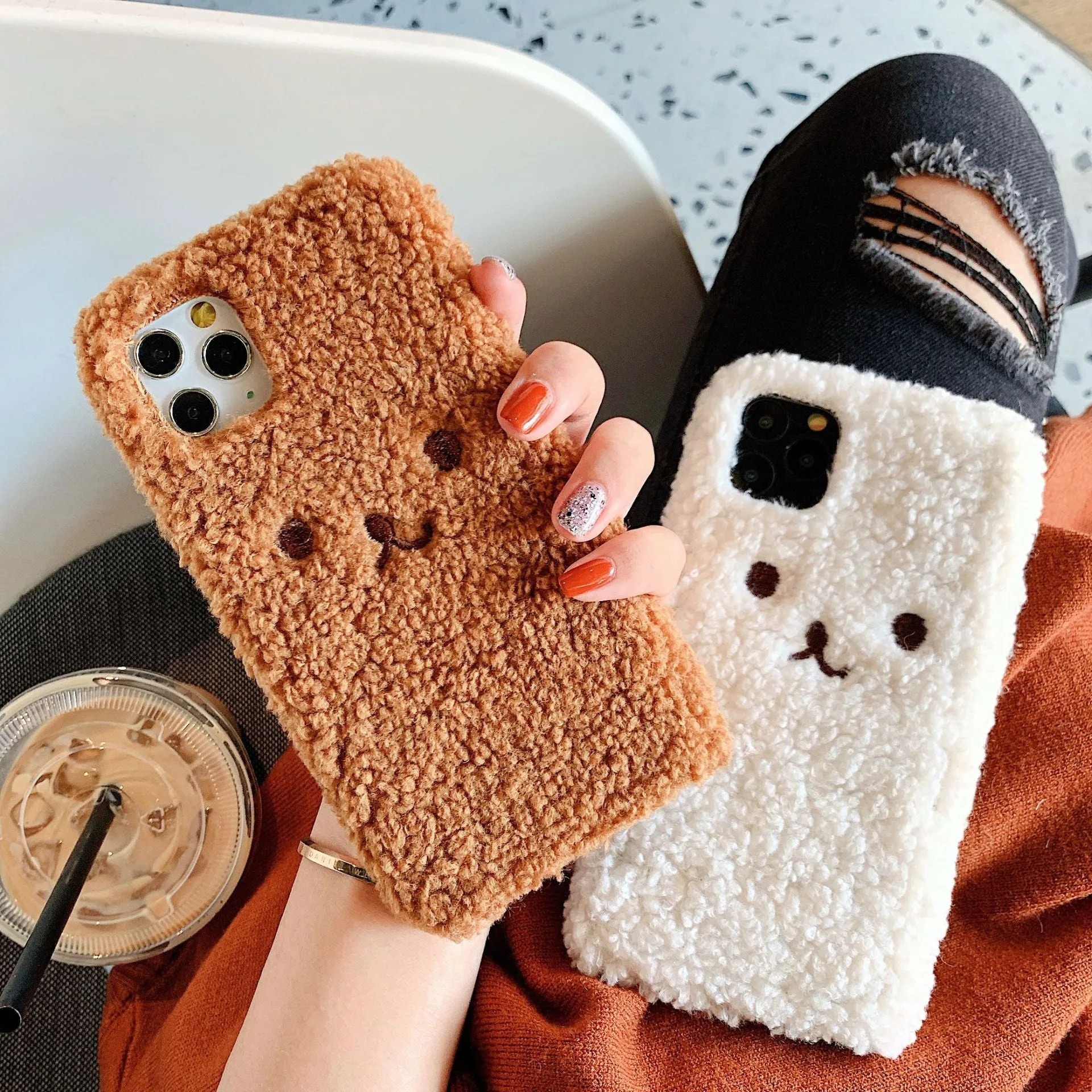 Brown embroidered plush cartoon bear face on a flexible TPU iPhone case.