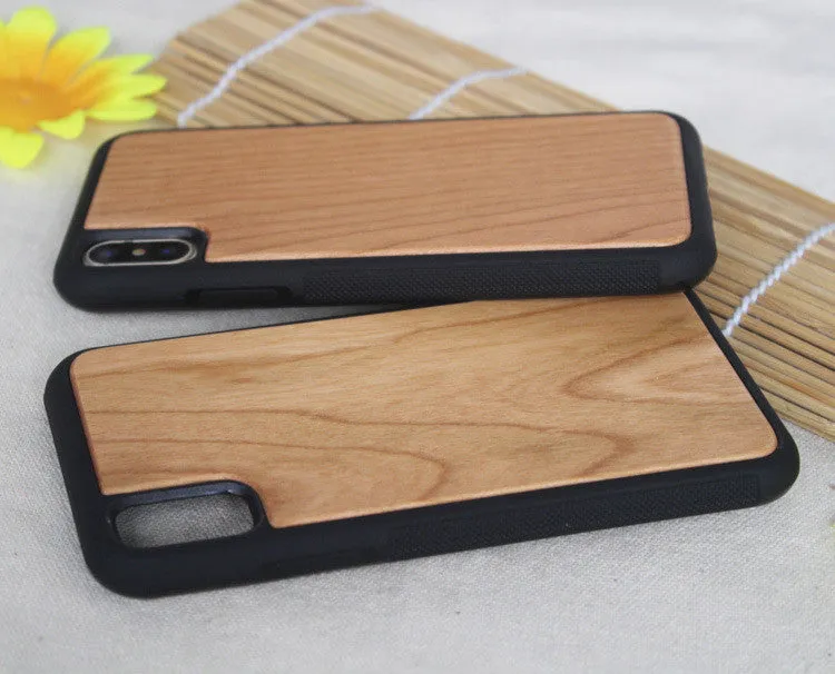 Wooden iPhone case with carbonised bamboo back and black TPU bumper frame on a wooden table.