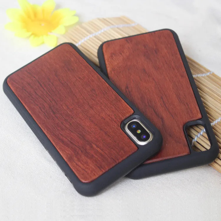 Wooden iPhone case with carbonised bamboo back and black TPU bumper frame on a wooden table.