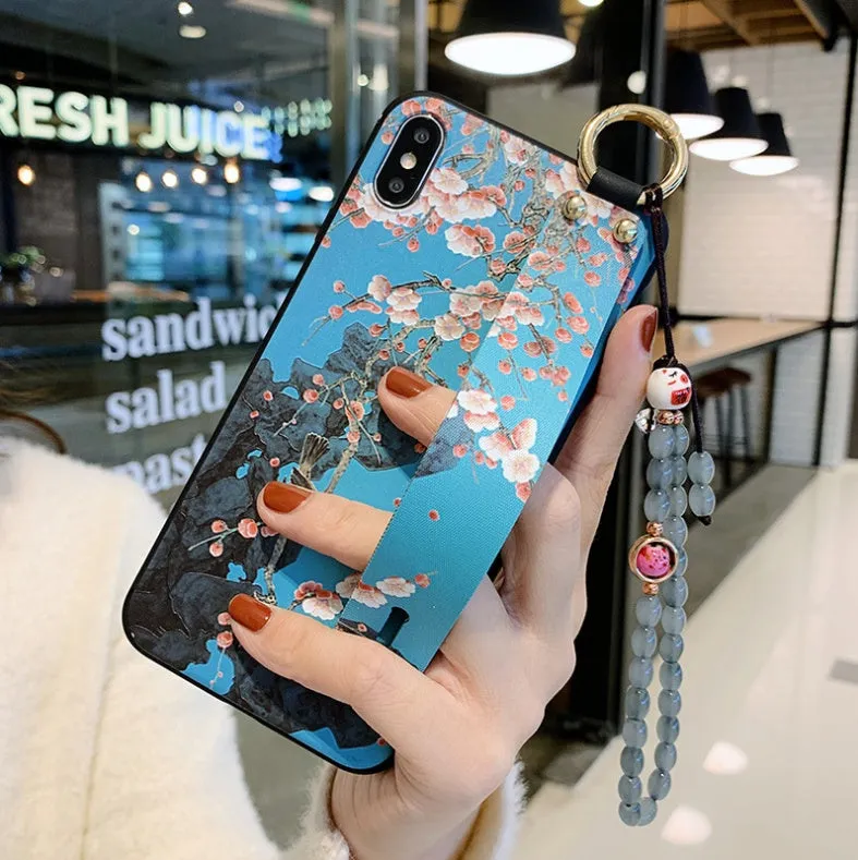 Compatible iPhone case with a detachable rose flower wrist strap, shown in one of ten available styles.