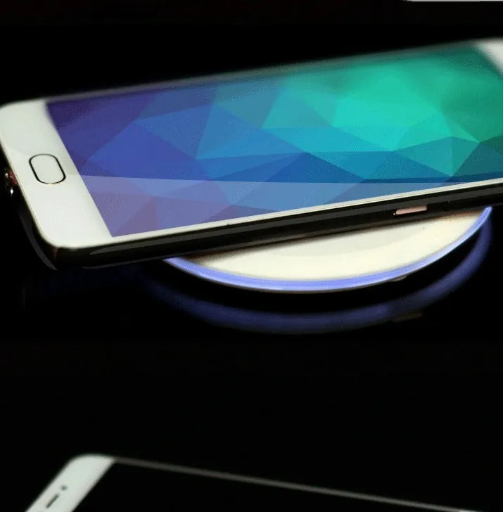 Ultra-thin wireless charger for mobile phone, black, with USB cable, showing charging indicator light