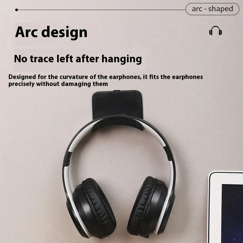 Black plastic headphone bracket mounted on wall with universal fit for headset storage