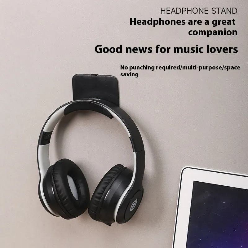 Black plastic headphone bracket mounted on wall with universal fit for headset storage