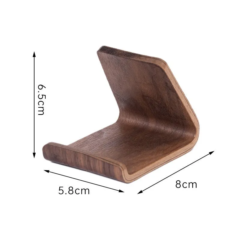 Walnut wood mobile phone bracket holding a smartphone on a wooden desk