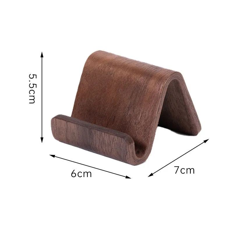 Walnut wood mobile phone bracket holding a smartphone on a wooden desk