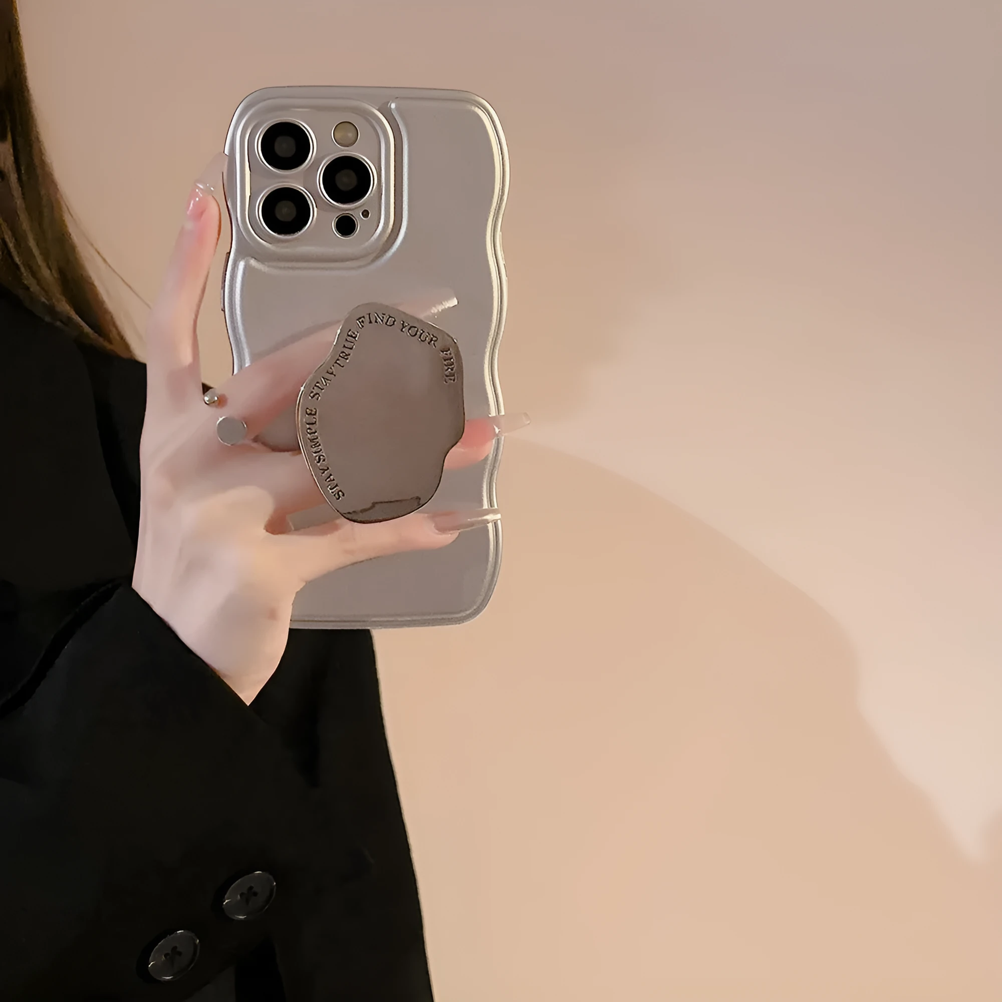 Silver metal bracket phone case for iPhone with electroplated finish and hand bead detail on gray background