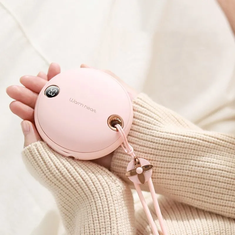 Green portable hand warmer power bank with digital display showing 5000mAh capacity