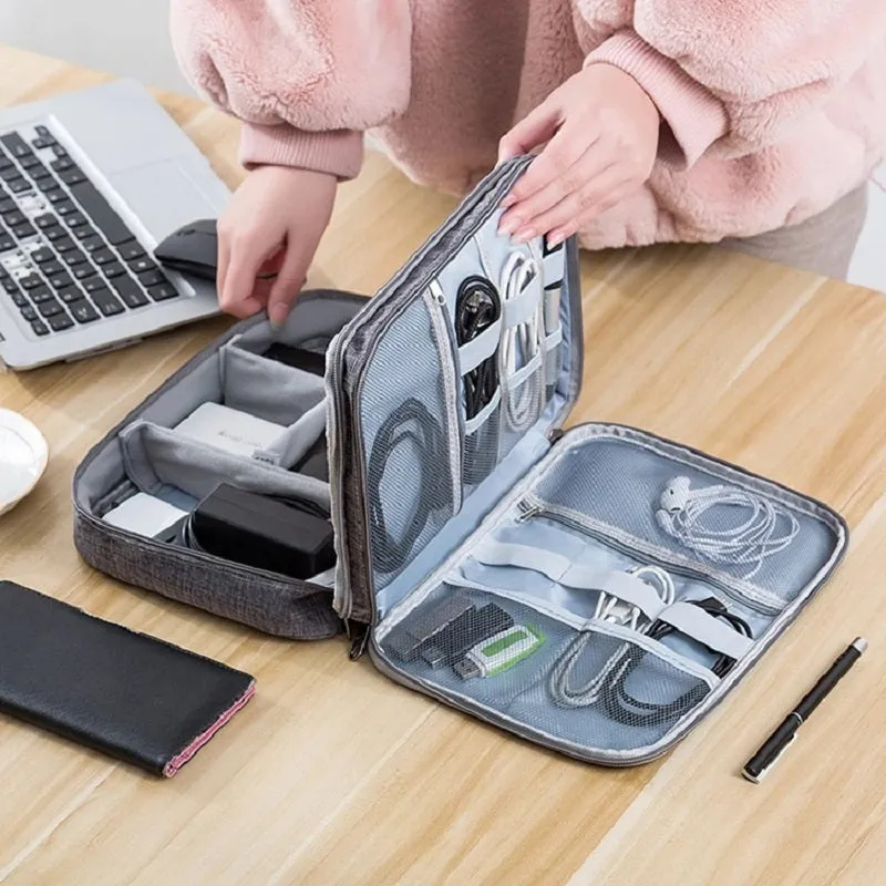 Grey waterproof electronics organiser with double-layer interior, adjustable dividers, and carrying handle