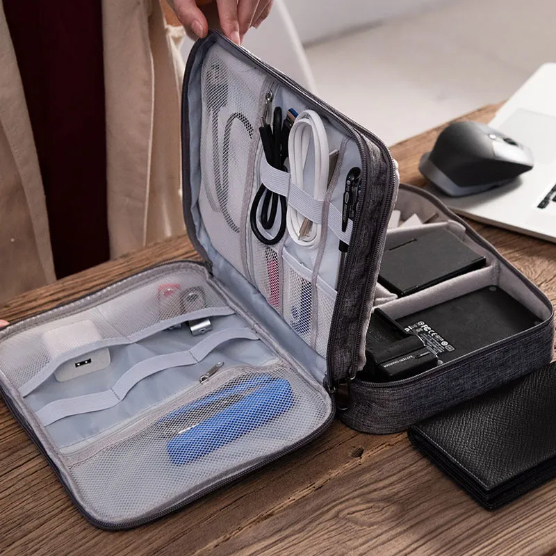 Grey waterproof electronics organiser with double-layer interior, adjustable dividers, and carrying handle